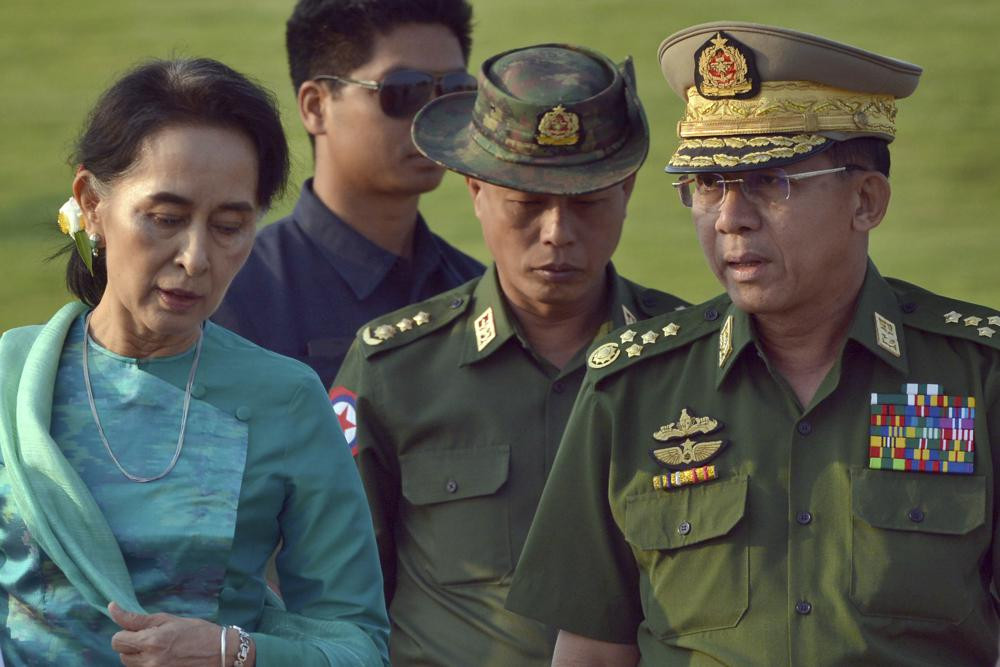 Aung San Suu Kyi, left, Myanmar's foreign minister and de facto leader, walks with Senior Gen. Min Aung Hlaing, right, commander-in-chief in the airport of capital Naypyitaw, Myanmar on May 6, 2016. Myanmar court on Monday, Dec. 6, 2021, sentenced ousted leader Suu Kyi to 4 years for incitement and breaking virus restrictions, then later in the day state TV announced that the country's military leader reduced the sentence by two years. (AP File Photo)